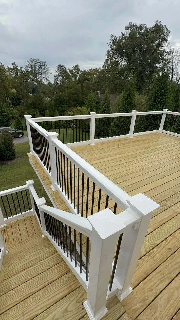 Wood deck with white railings and black balusters
